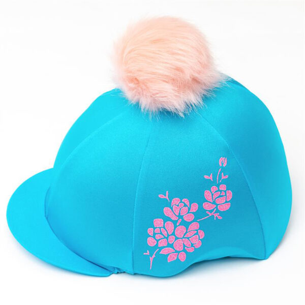 Cherry Blossom Riding Hat Cover: A stunning turquoise riding hat cover with a glittery pink cherry blossom branch design and a very fluffy pink pom pom