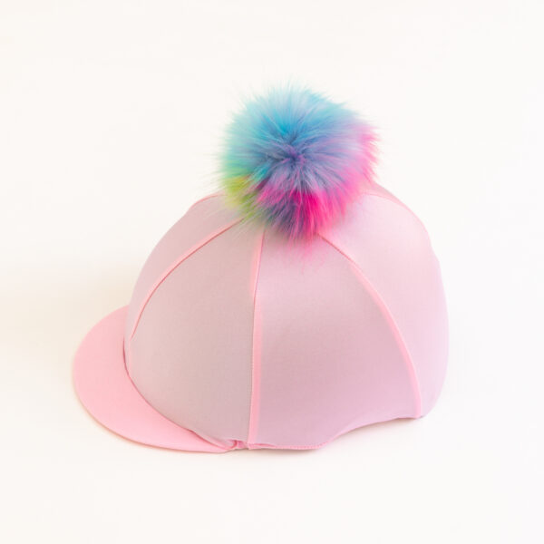 Light Pink Riding Hat Cover: Our very fluffy Unicorn Rainbow Poms on a pretty light pink hat cover. They can be personalised in a selection of colours.