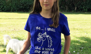 A young girl wearing a pony-themed T-shirt. It's Time For T-shirts. UK weather has decided to move from cold spring to hot summer at full speed. Hooray for our pony-themed T-shirts