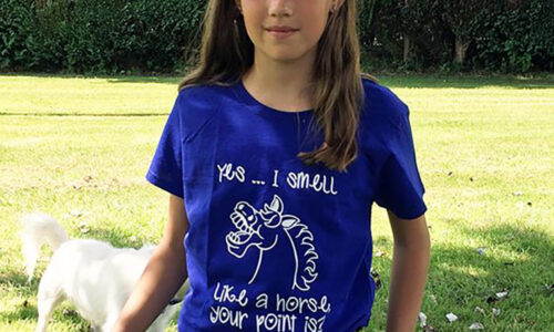 A young girl wearing a pony-themed T-shirt. It's Time For T-shirts. UK weather has decided to move from cold spring to hot summer at full speed. Hooray for our pony-themed T-shirts